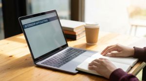 College student reviewing internship notes and career plans at a laptop